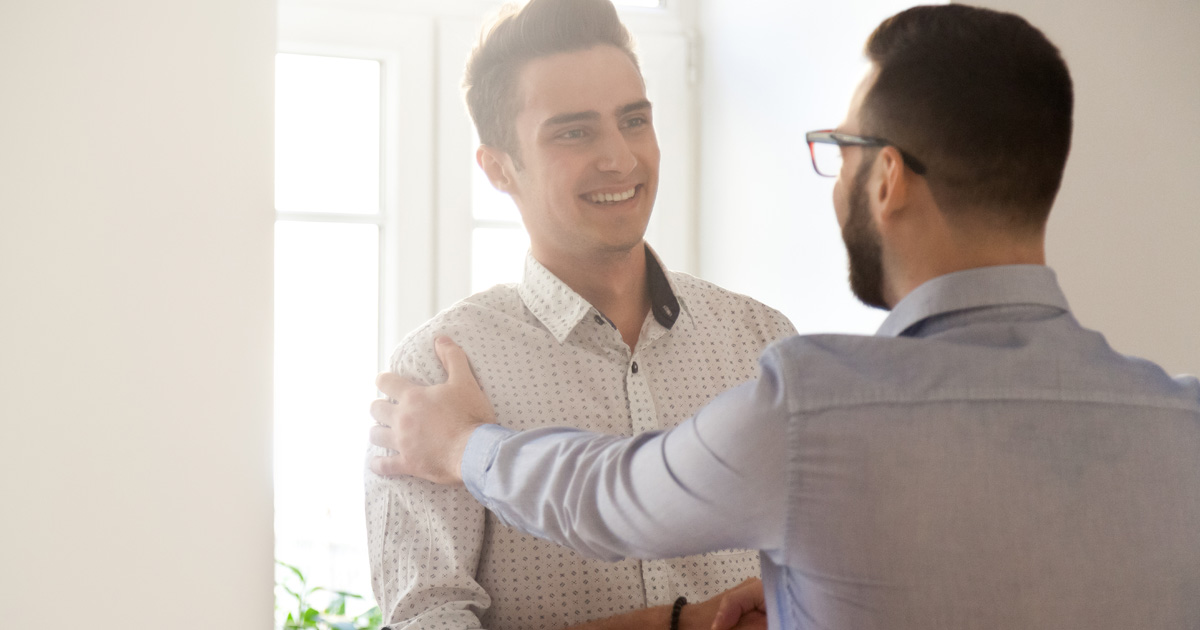 Grateful boss handshaking employee congratulating with job promotion
