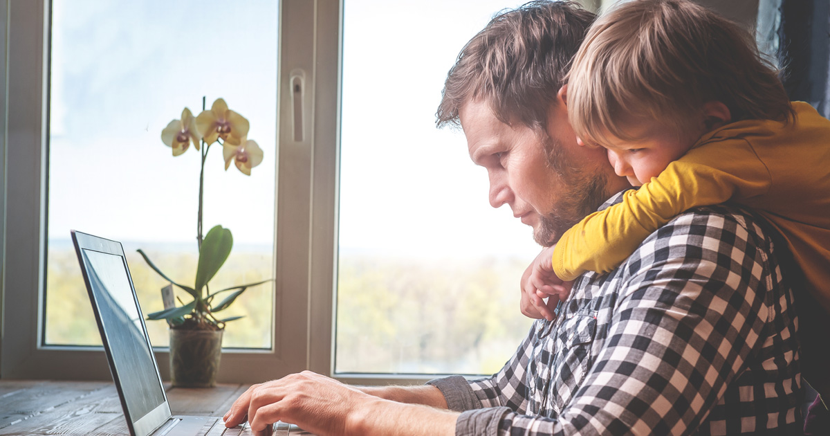Father and son working on laptop