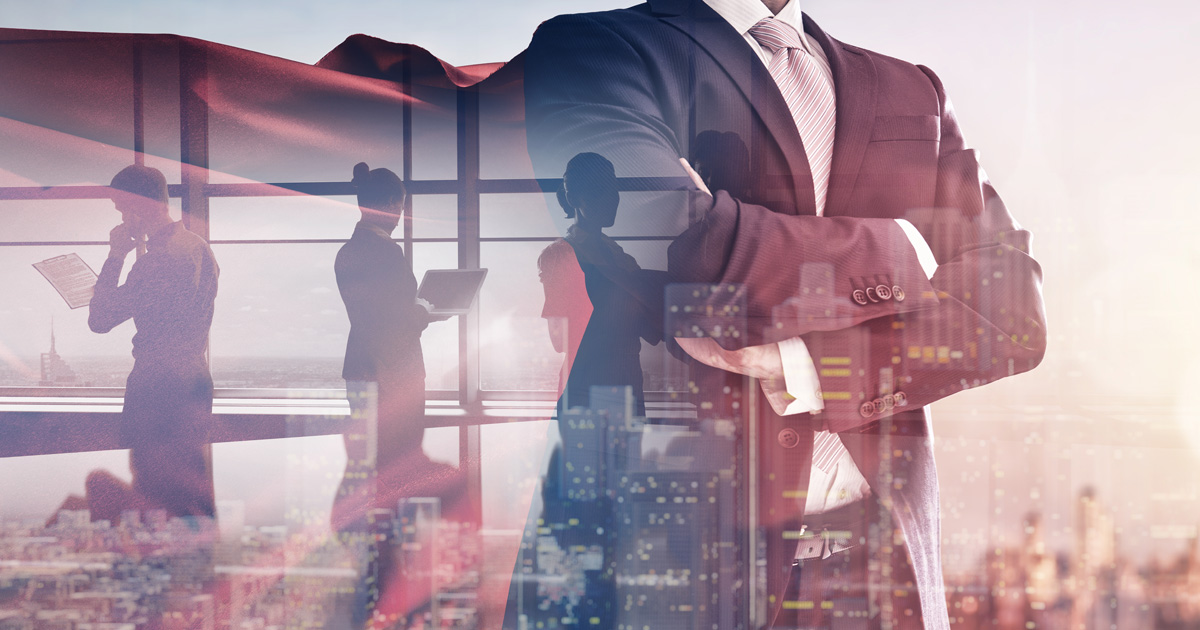 Businessman looking at city skyline at sunset