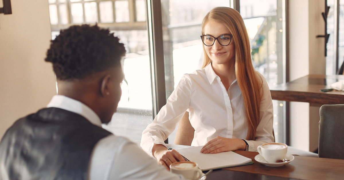 Man being interviewed by a woman