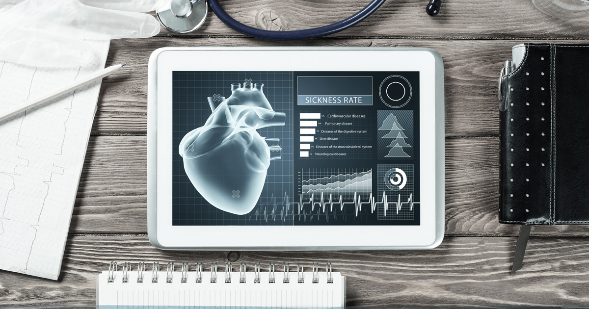 White tablet pc and doctor tools on wooden table