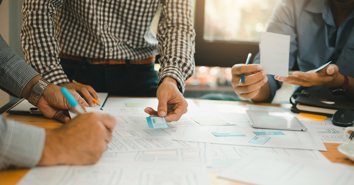 Ux designer designing web layout geek business prototype internet goals sketch plan write idea success solution meeting concept