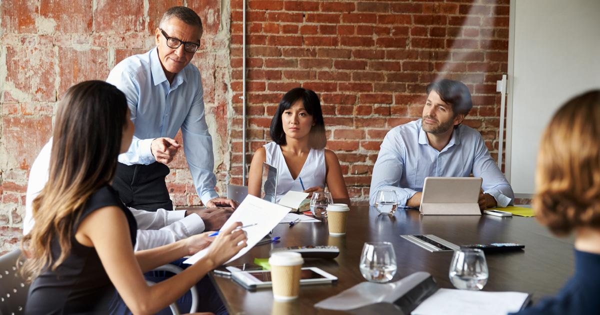 Business people meeting in modern boardroom through glass