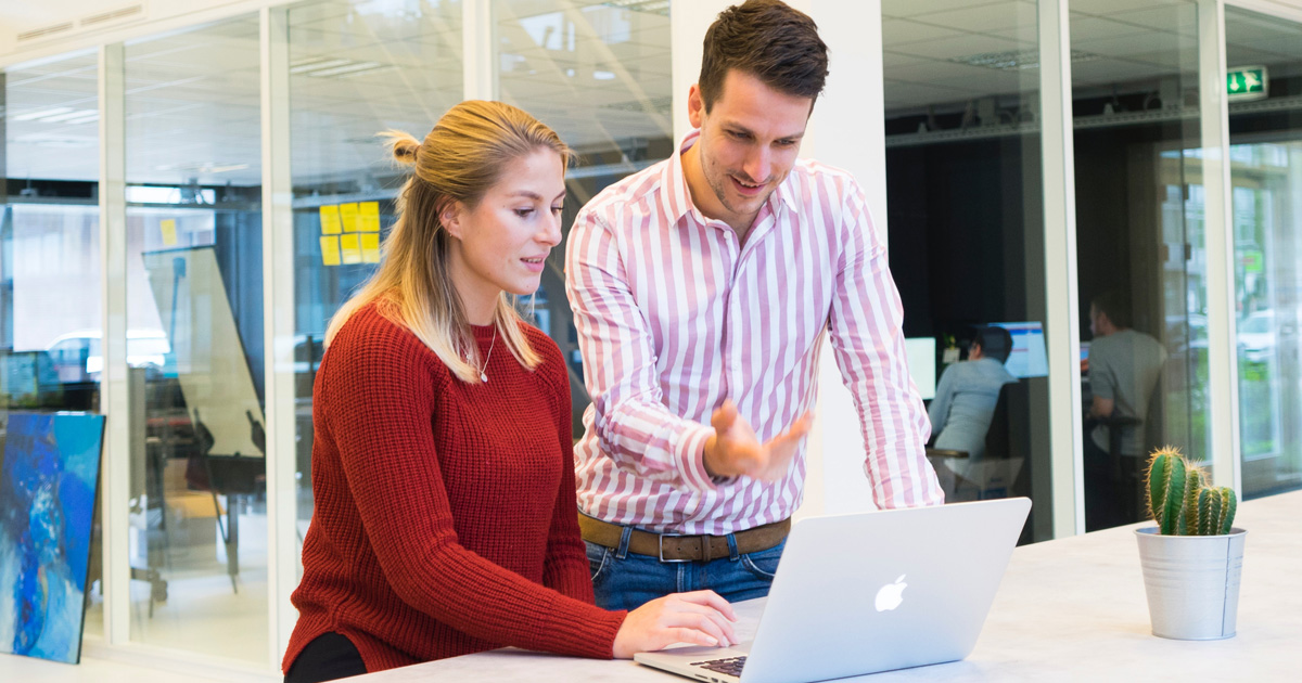 Photo of a man and woman using a laptop computer