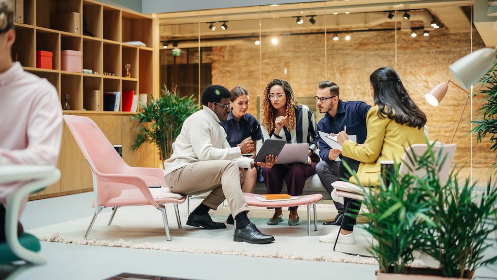 Group of professionals discuss agile change management plan.