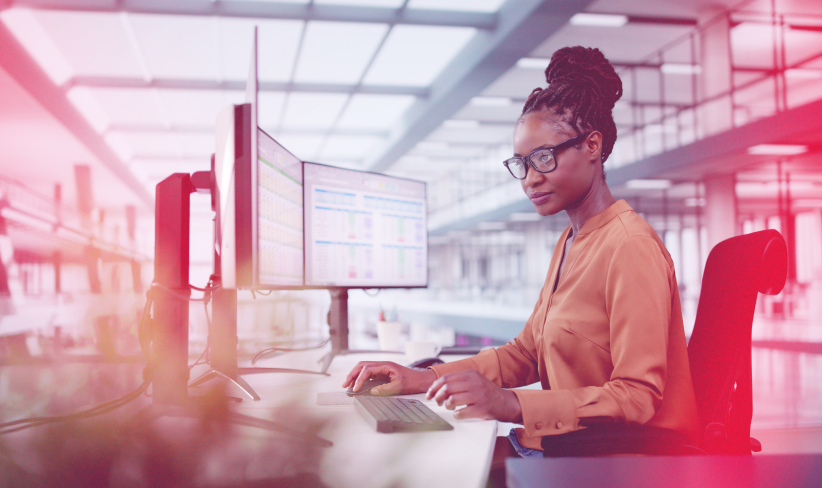 Woman sitting at computer desk working on data governance
