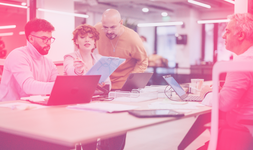 Group of coworkers discuss data analytics strategy at a conference table