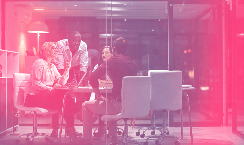 Group of executives gather at a conference table to discuss supply chain trends for 2025