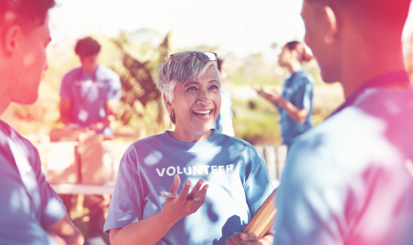 Woman working for a nonprofit speaks with other volunteers