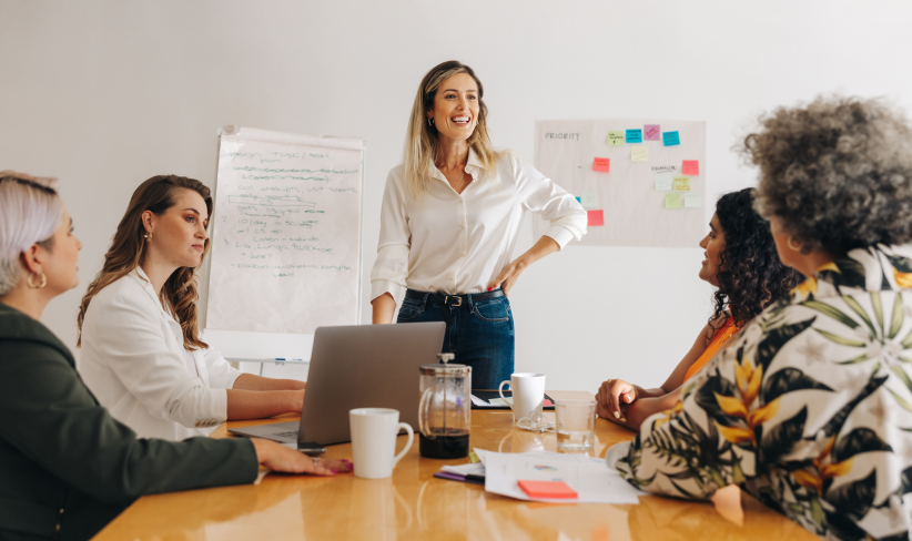 Group of business professionals sitting at a table discussing their AI readiness